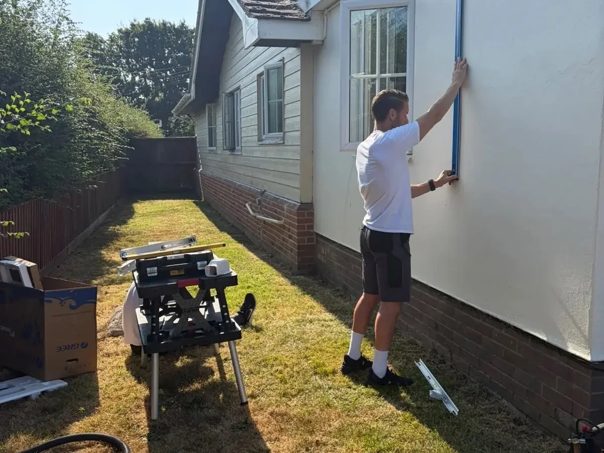 Perennia Climate Services engineer installing a wall-mounted indoor air conditioning unit