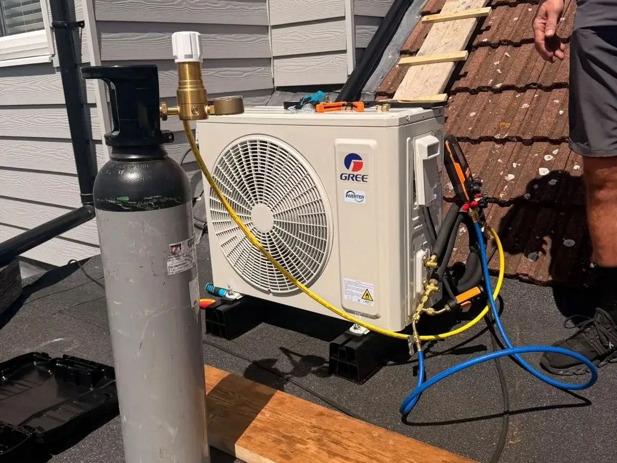 Outdoor air conditioning unit with manifold gauges connected during a Perennia Climate Services visit