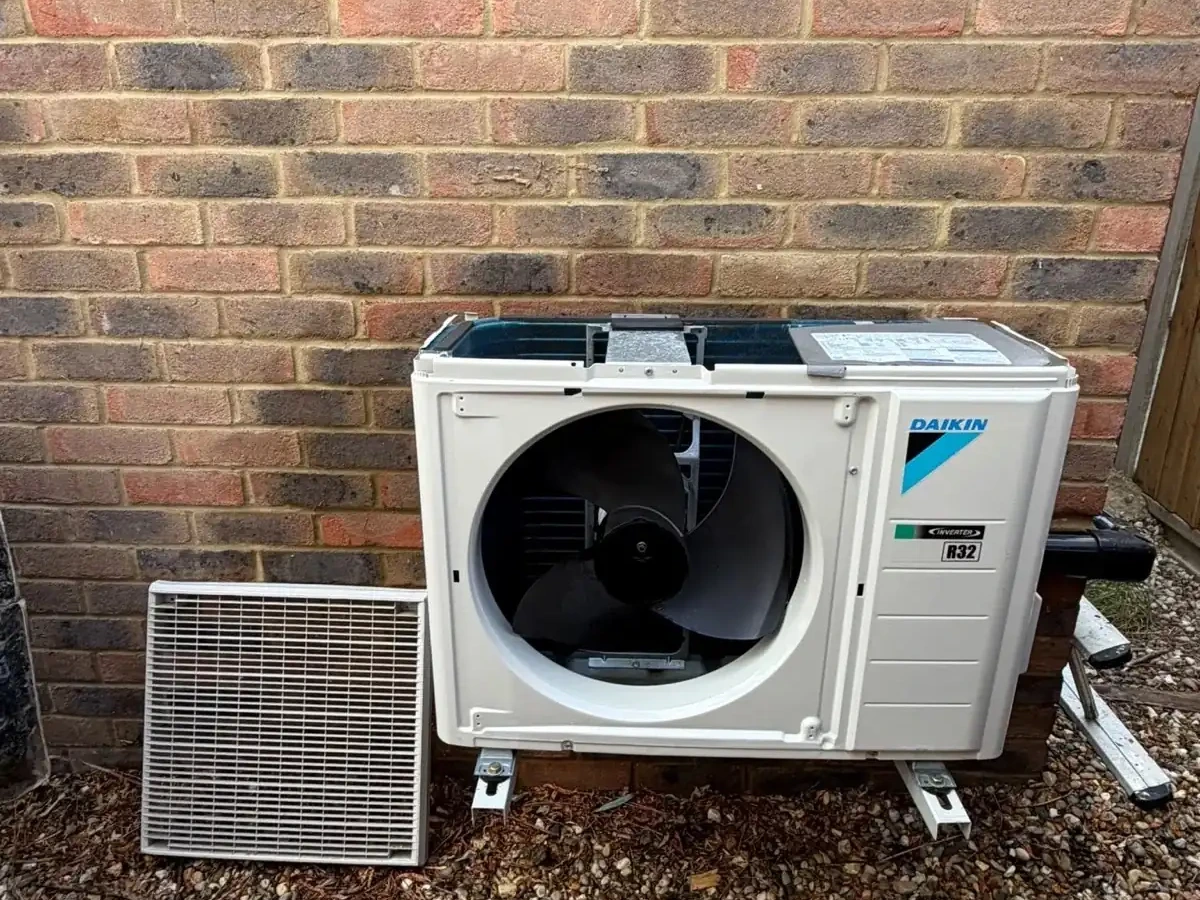 Perennia Climate Services engineer commissioning an outdoor air conditioning condenser on a residential install